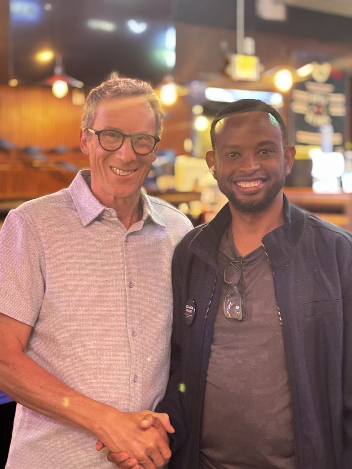 Abdihakim Ibrahim shaking hands with Minnesota State Senator Ron Latz
